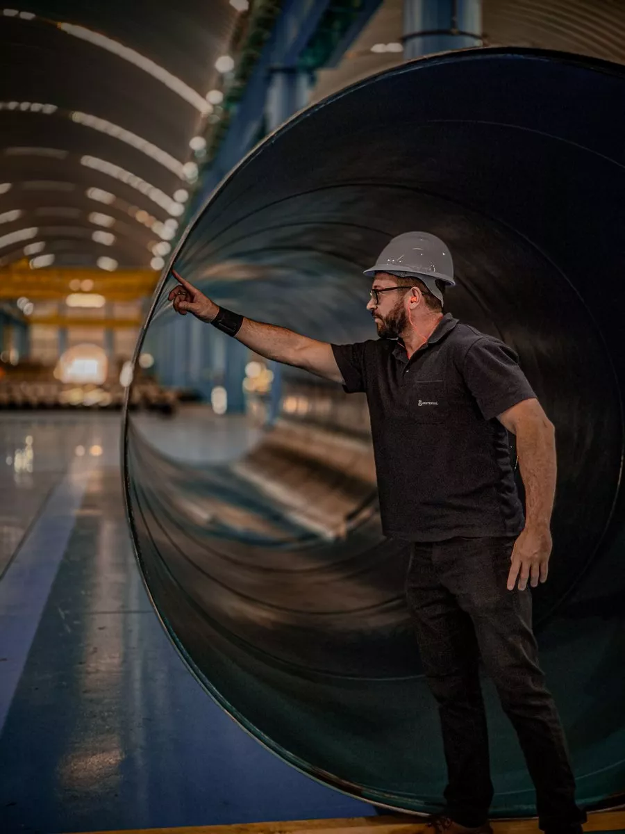 Visual and dimensional pipe inspection Inspector performing visual and dimensional checks on a large steel pipe