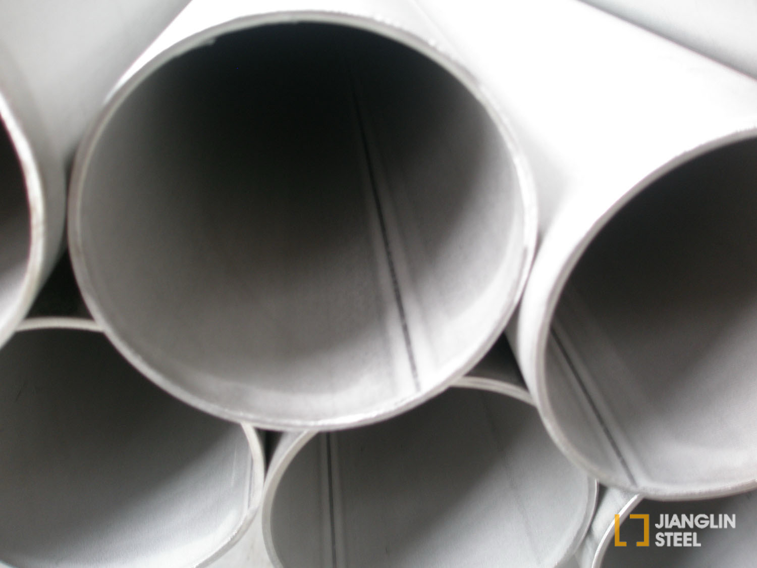 Interior view of Jianglin welded stainless steel pipes showing longitudinal seam lines